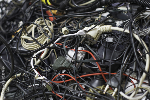 a bunch of tangled wires, connectors and cables