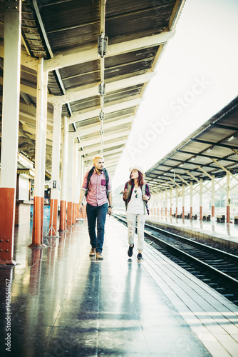 Couple holiday concept : Young hipster couple in train station.