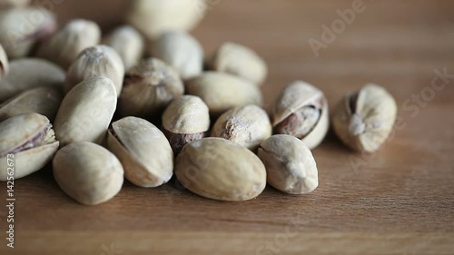 Phistachio nuts on the wood background photo