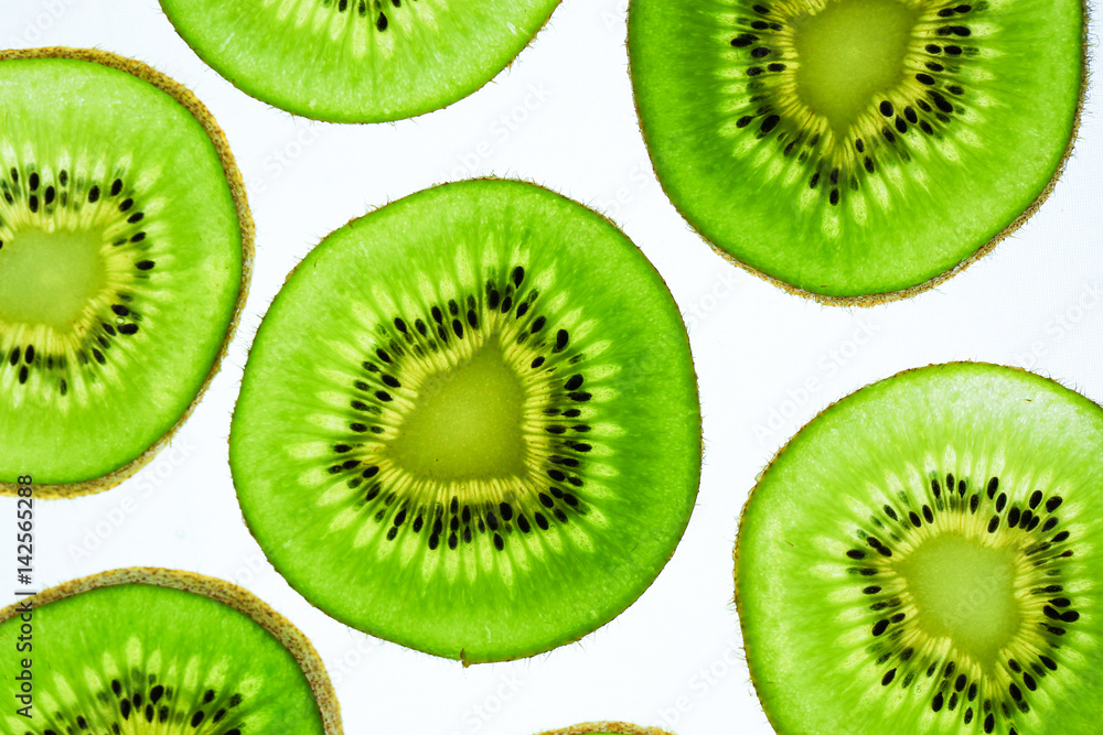 Still life picture, Abstract fruit background is close up on Kiwi slice, to show a detail on fresh kiwi face with white background Still life picture, Abstract fruit background is close up on Kiwi slice, to show a detail on fresh kiwi face with white background
