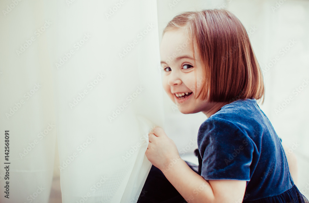 The pretty girl sits on the window-sill The pretty girl sits on the window-sill