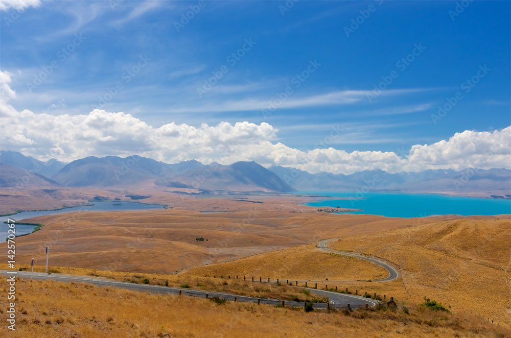 マウントジョン山頂からドライブウェイと黒いAlexandrina湖、青いテカポ湖を望む