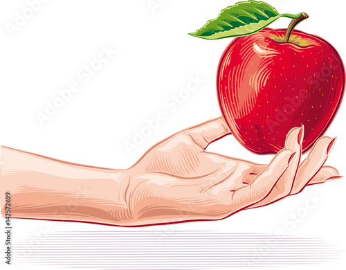 Female hand offering an apple.