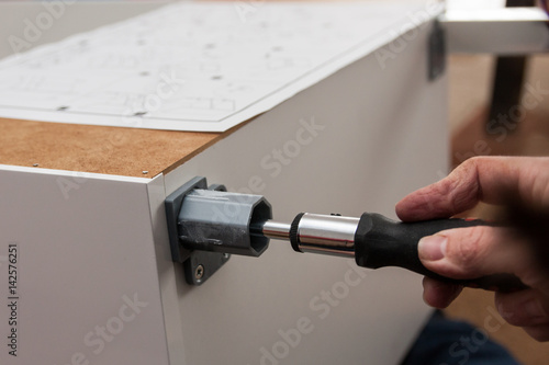assembling cupboard with screwdriver