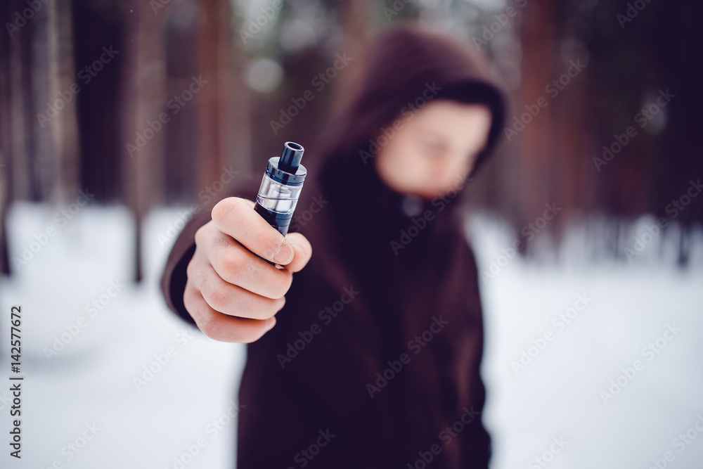 vaping man holding a mod device. cloud of vapor. Vape vaping man holding a mod device. cloud of vapor. Vape