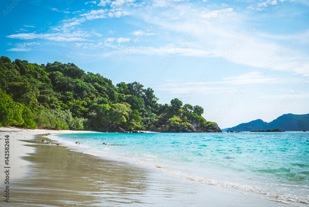 The beach and mountains scenery with blue sky The beach and mountains scenery with blue sky
