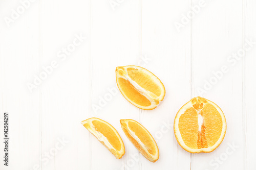 Slices of orange on a wooden white background