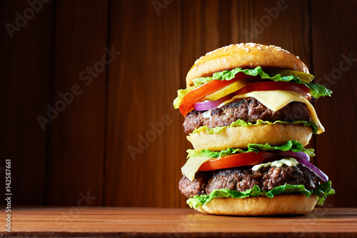 Big hamburger on wooden background