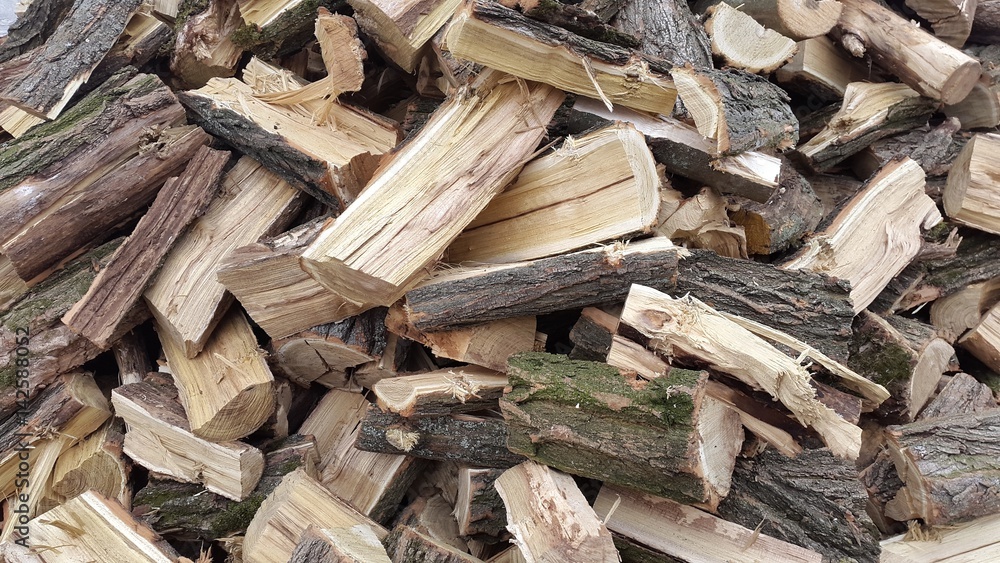 Throwing firewood on a pile. Stack with firewood. Throwing firewood on a pile. Stack with firewood.