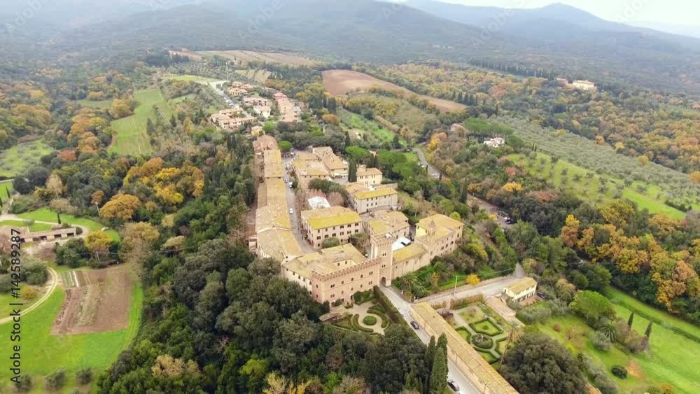 Aerial shot, a small ancient town situated in the middle of rural landscape with cultivated field and a lot of olive trees in Tuscany, Italy, shot with drone Aerial shot, a small ancient town situated in the middle of rural landscape with cultivated field and a lot of olive trees in Tuscany, Italy, shot with drone