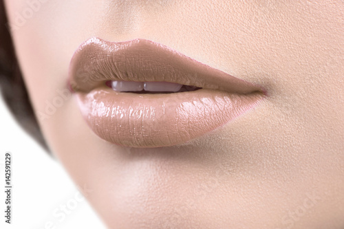 Perfect lips. Close up cropped shot of a woman wearing light brown lip gloss luscious flawless perfect unblemished healthy beautiful lips natural makeup cosmetics face plump femininity concept