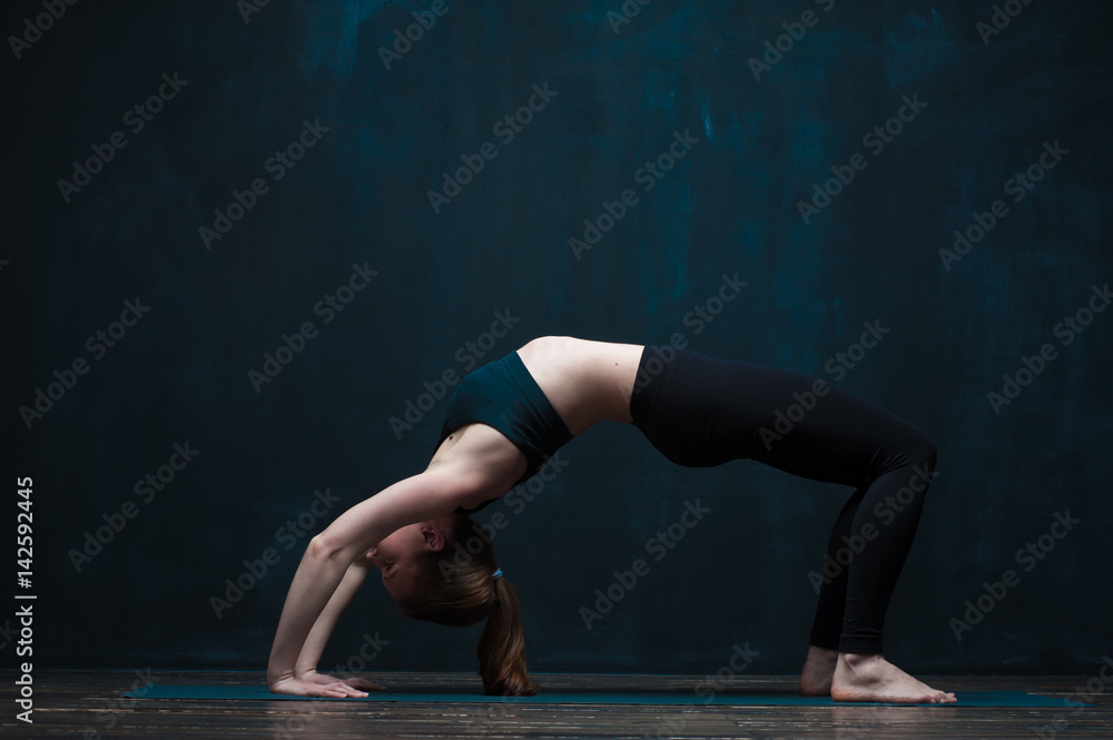 Flexible woman practicing advanced yoga asana Flexible woman practicing advanced yoga asana