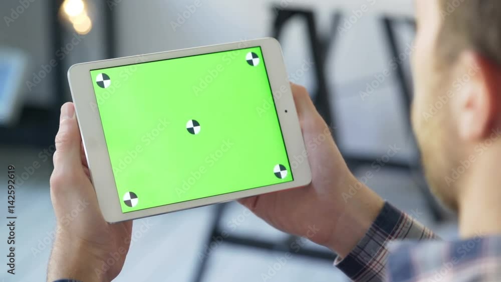 Man use Digital Tablet with touch green screen for browsing communicating closeup. Male, holding in hand portable gadget close-up, as image of tech accessibility concept