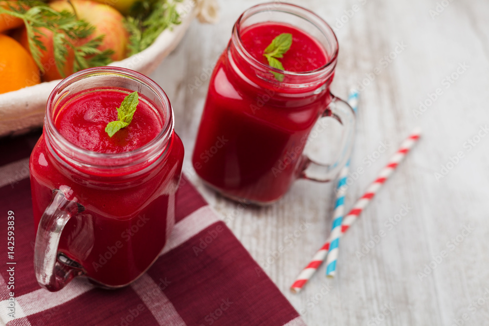 Vegetable and fruit cocktail, served in a jar, with fresh beets, carrots and apples.