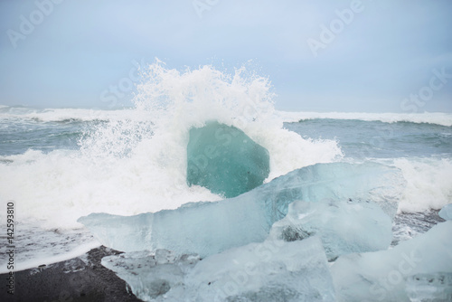 Spalshes of Sea Waves on Ice Blocks photo