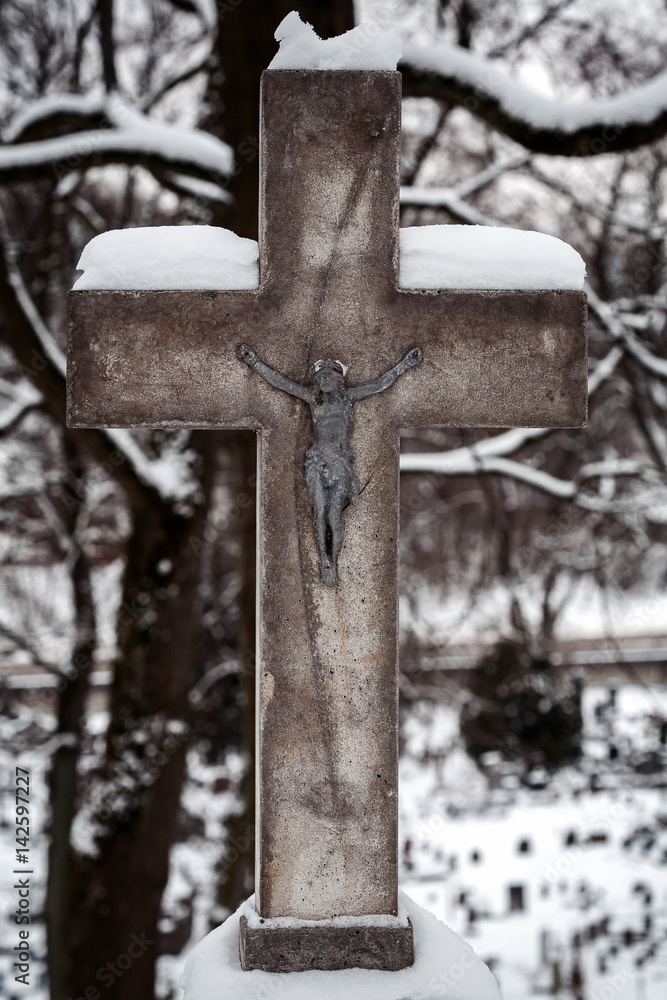 Christian cross covered with snow Christian cross covered with snow