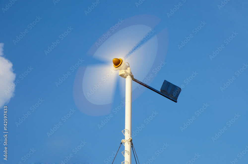 Mini 10kW wind turbine spinning on blue sky at Phuket, Thailand. wind turbine spinning on blue sky at Phuket, Thailand. Mini 10kW wind turbine spinning on blue sky at Phuket, Thailand. wind turbine spinning on blue sky at Phuket, Thailand.
