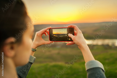 Girl takes pictures of the landscape