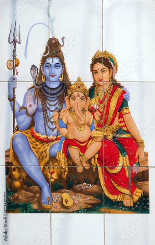 Colorful illustration of Hindu goddess Shiva with Annapurna and Ganesha on the wall in Kolkata, India 