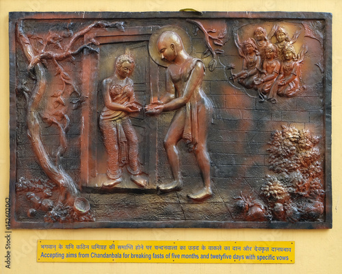 Accepting aims from Chandanbala for breaking fasts of five months and twenty five days with specific vows, Street bass relief on the wall of Jain Temple in Kolkata photo