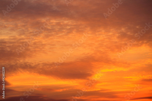 Fiery orange cloudy sky at sunset © olyasolodenko