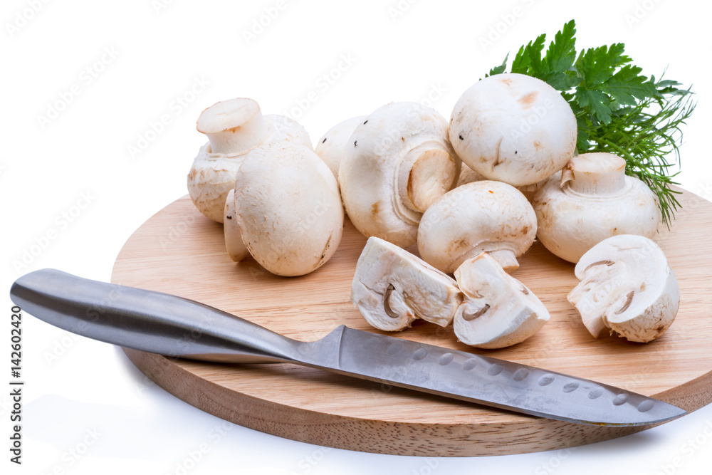 Champignons on a cutting board and knife Champignons on a cutting board and knife