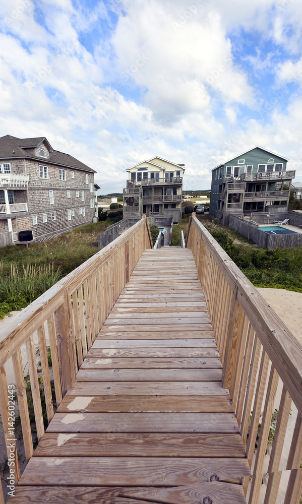 Wooden walkway leading to upscale vacation beach rentals. Wooden walkway leading to upscale vacation beach rentals.