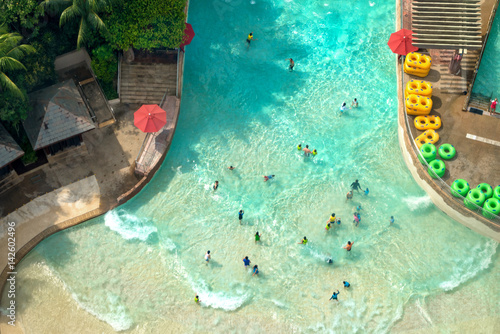 Top view of water park with many traveler have fun swimming pool in Sentosa, Singapore. photo