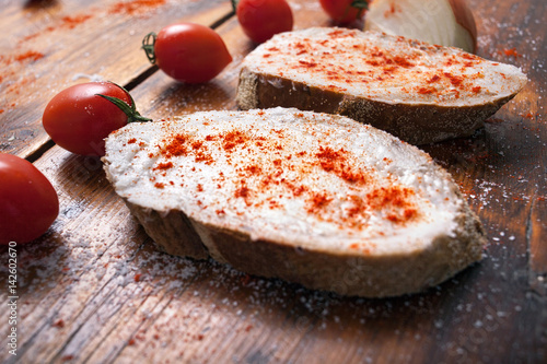 Traditional Serbian food, bread with lard and sprinkled with red ground pepper