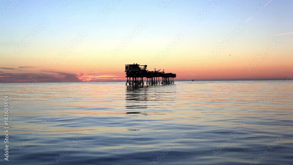 Silhouette of offshore oil platform at sunset Silhouette of offshore oil platform at sunset