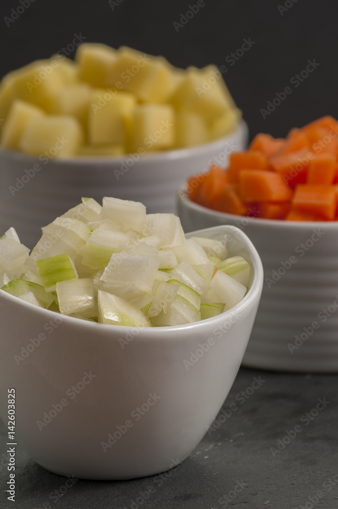 chopped vegetable in white bowls on wood chopped vegetable in white bowls on wood