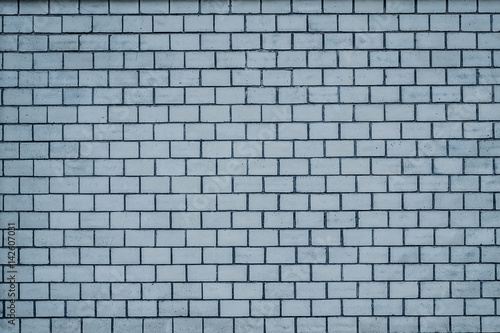An old pale blue brick wall texture for background