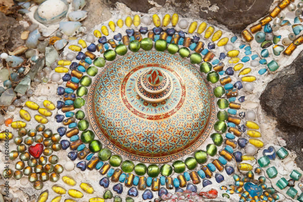 Colorful ceramic pattern decoration with pebbles made from pebble and ceramic on the wall at Wat Phasornkaew., Phetchabun Province, Thailand..