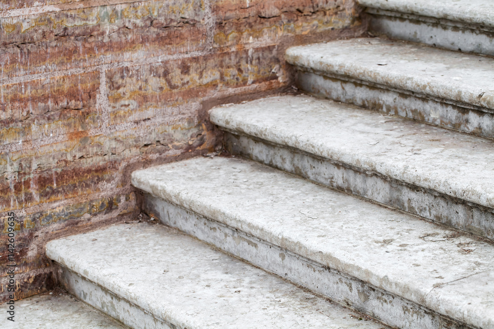 Old concrete stairway goes near brick wall Old concrete stairway goes near brick wall