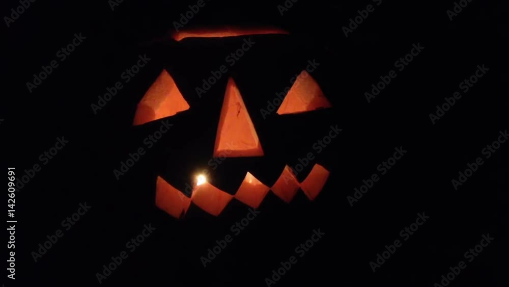 Jack O Lantern background filmed at night with real candle. Authentic carved pumpkin Jack O Lantern background filmed at night with real candle. Authentic carved pumpkin