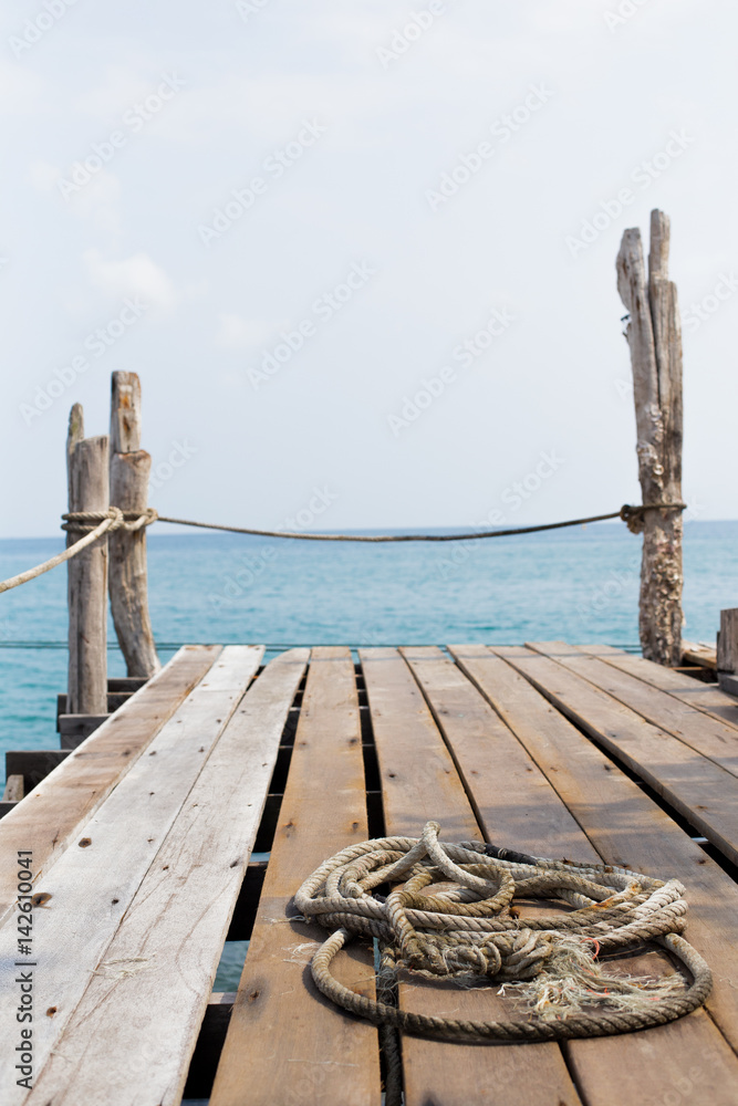 Rope on wood dock by the sea in Thailand