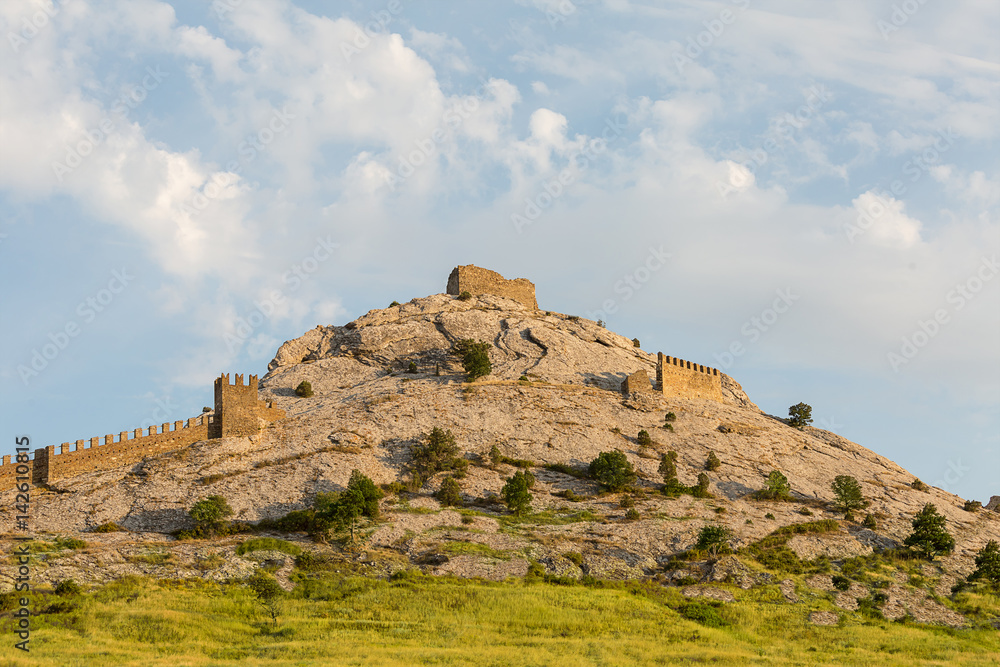 Crimea Sudak high mountain part of the fortification of the old fortress against the blue sky background