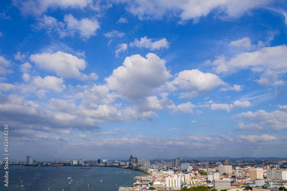 Pattaya cityscape and pattaya sea bay in top view with blue sky and cloud  is city is famous tourist Attractions about sea sport and night life entertainment, Chon Buri, Thailand