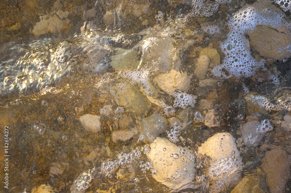 sea pebble beach with multicoloured stones, waves with foam sea pebble beach with multicoloured stones, waves with foam