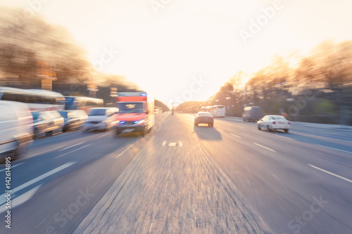 Ambulance on urban street, zoom motion blur