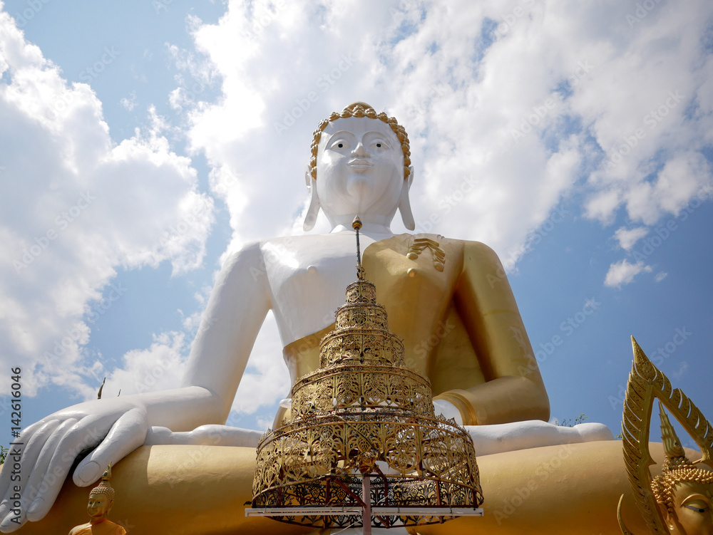 Fototapeta premium Low angle of giant Buddha statue at Wat Phra That Doi Kham (Temple of the Golden Mountain) in Chiang Mai, Thailand