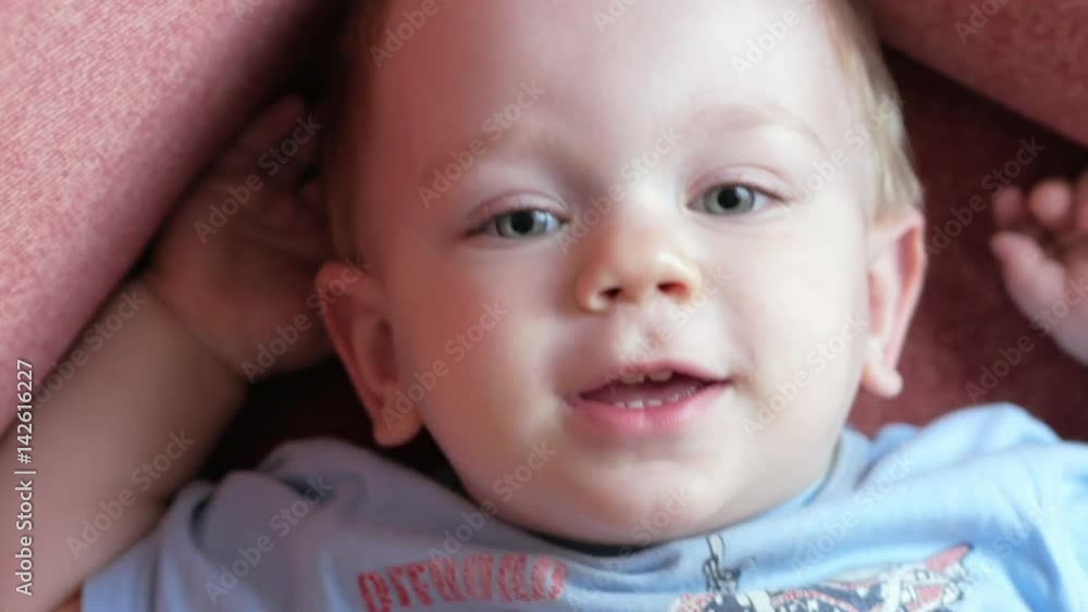 An attractive boy 2 years old is looking at the cameras and playing facial expressions. He smiles, screams, closes his eyes and frowns. An attractive boy 2 years old is looking at the cameras and playing facial expressions. He smiles, screams, closes his eyes and frowns.
