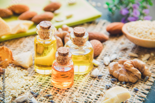 Fototapeta Naklejka Na Ścianę i Meble -  Cosmetic and medical oil of walnuts, almonds, cocoa butter close-up