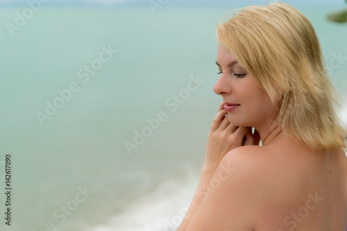 Young blonde woman on a beach lounger