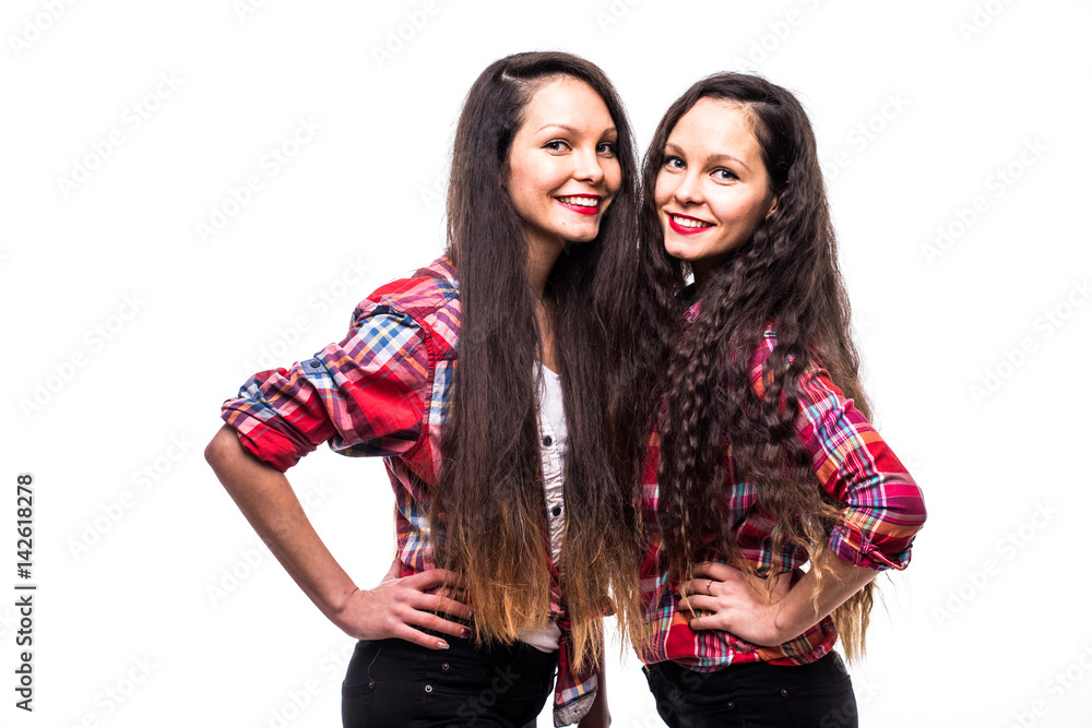 Twins in stylish summer outfit on white background Twins in stylish summer outfit on white background