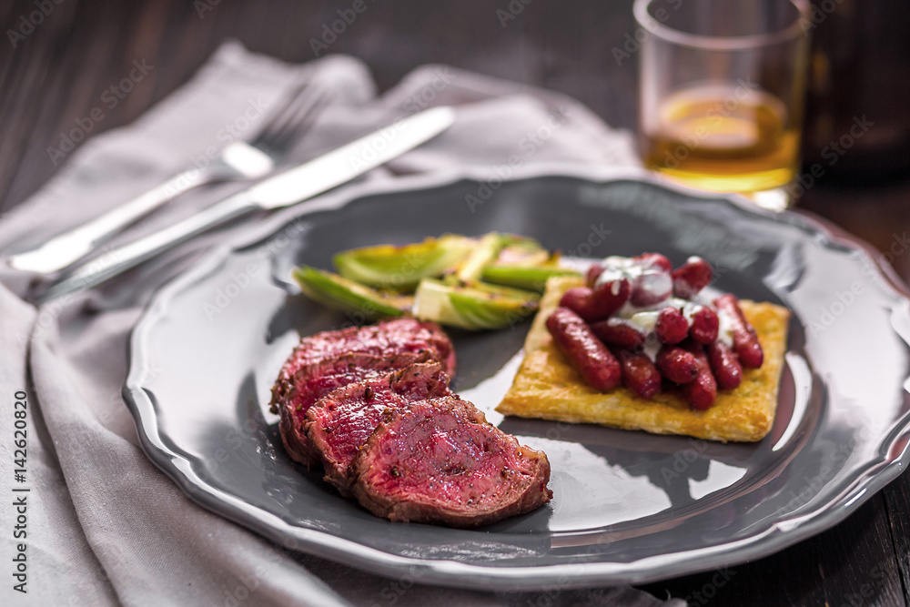 Sliced beef steak with grilled vegetables on a plate Sliced beef steak with grilled vegetables on a plate