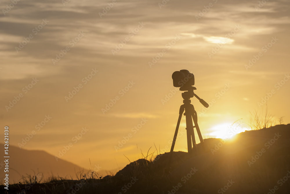Photo camera at sunset in the mountains