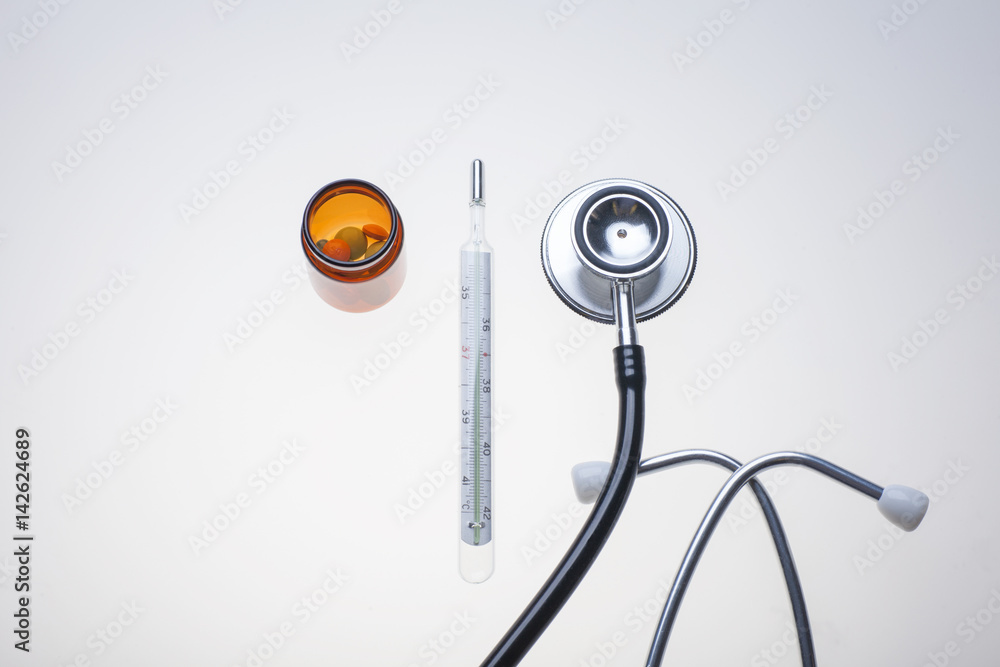 various medicine drugs with thermometer and stethoscope on lab light table various medicine drugs with thermometer and stethoscope on lab light table