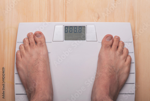 men feet on modern scales with template numbers of weight