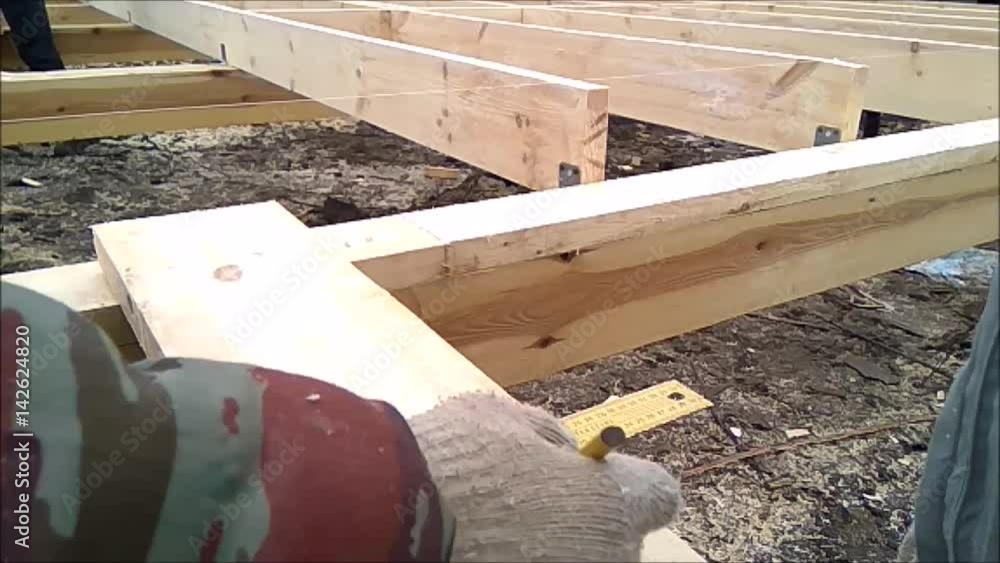 Slow Motion (Slow Mo) Man cuts off beam chainsaw for future log cabin. Construction works with a wooden structure Slow Motion (Slow Mo) Man cuts off beam chainsaw for future log cabin. Construction works with a wooden structure